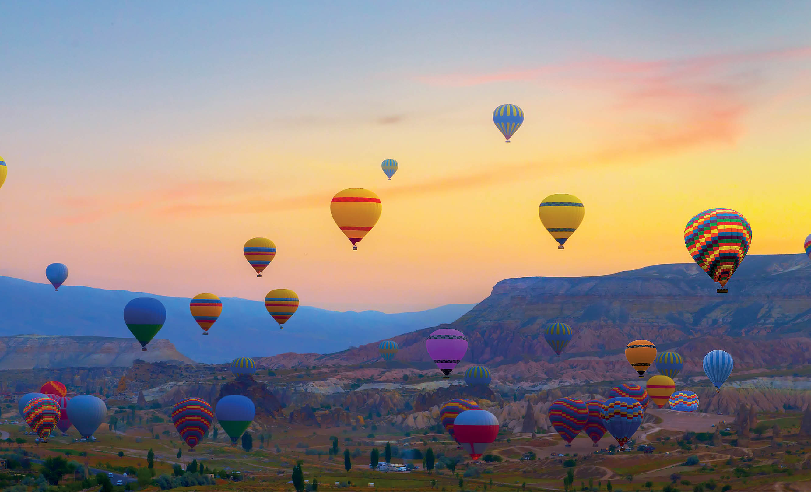 sunset Hot air balloons landing in a mountain Cappadocia Goreme National Park Turkey 